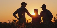 Un groupe d'agriculteur qui discute sous un couché de soleil